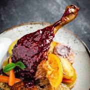 Roasted Fat Goose Leg with Potatoes, Carrots and Oranges