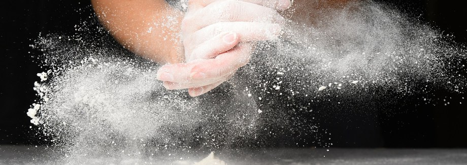 Clap hands of baker with flour